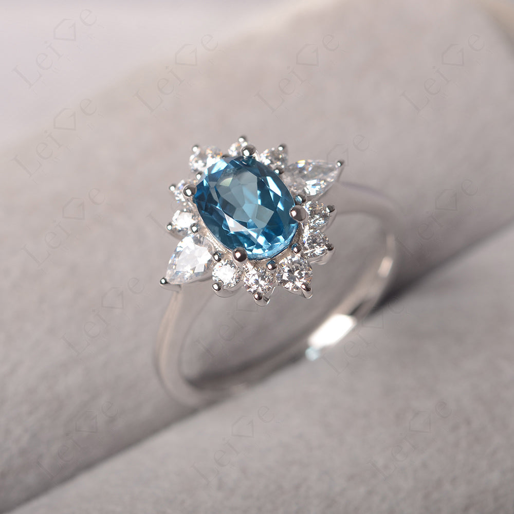 Oval Cut Swiss Blue Topaz Ring With Pear Side Stone