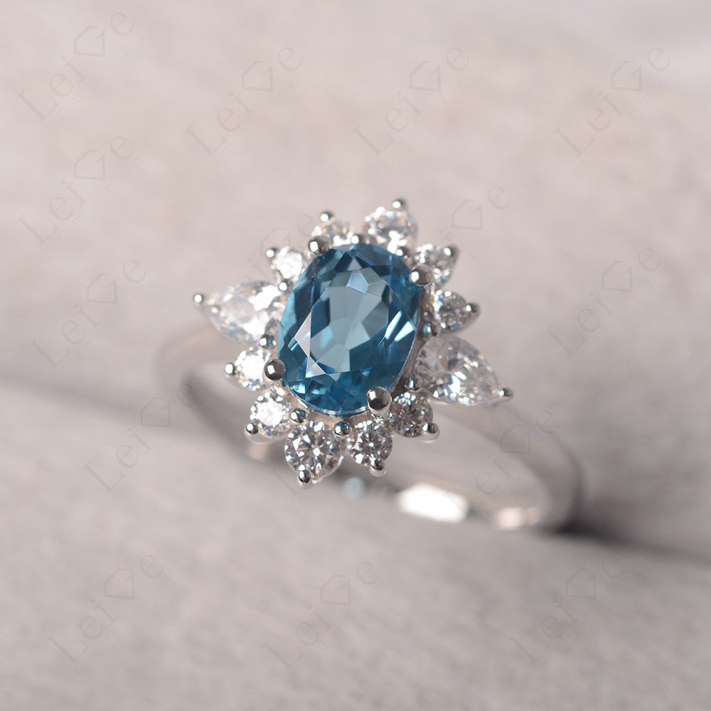 Oval Cut Swiss Blue Topaz Ring With Pear Side Stone