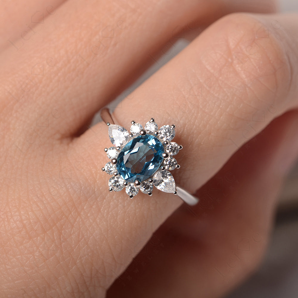 Oval Cut Swiss Blue Topaz Ring With Pear Side Stone